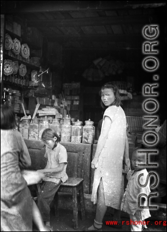 Kids in a small retail shop in China during WWII.    From the collection of David Firman, 61st Air Service Group.