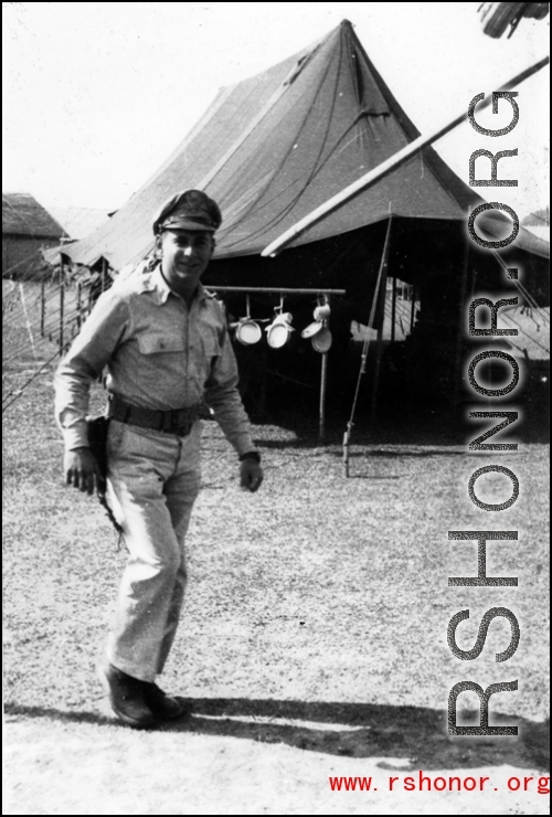 GI walks in front on a tent in India during WWII.  From the collection of David Firman, 61st Air Service Group.