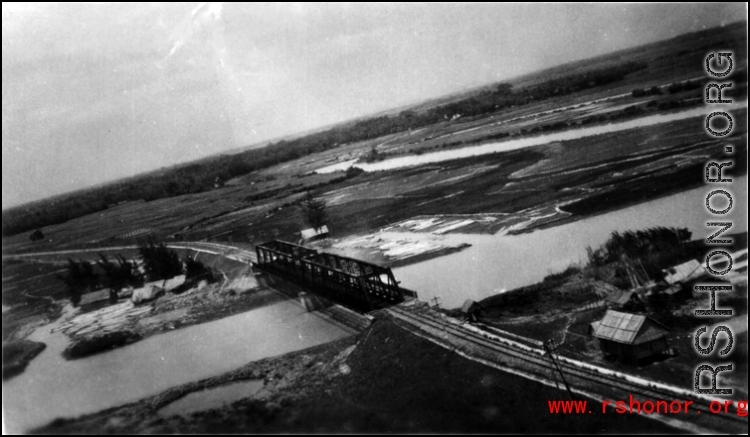 An aerial photograph of a railway bridge being bombed by the 491st Bomb Squadron in Yunnan or Indochina, during WWII.