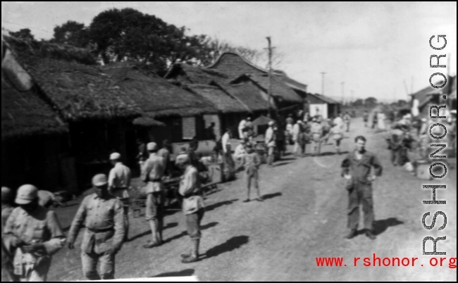 GI Joe and Chinese soldiers on a village street, probably outside of Yangkai base, Yunnan.