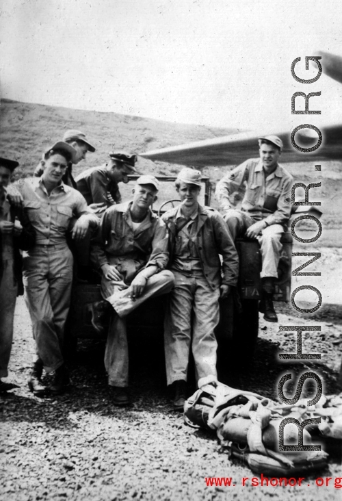 "Mission time." American flyers prepare themselves for another mission during WWII. Note the parachutes at the ready on the ground.