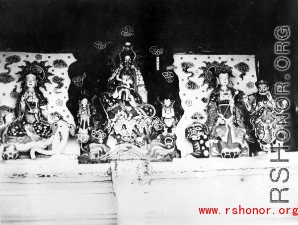 Figures inside a Buddhist temple in China. During WWII.