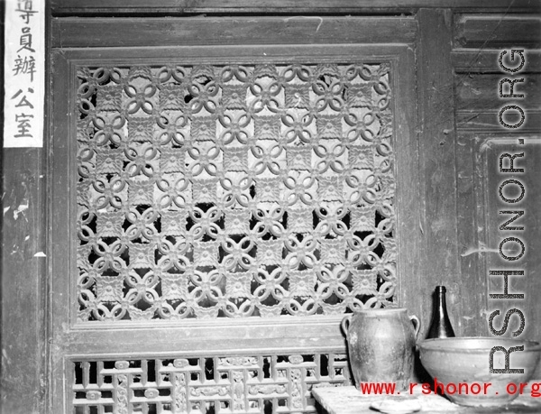 Traditional woodwork on door panels in China. During WWII.