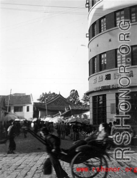 Local people on a street and market in in Kunming city, Yunnan province, China.