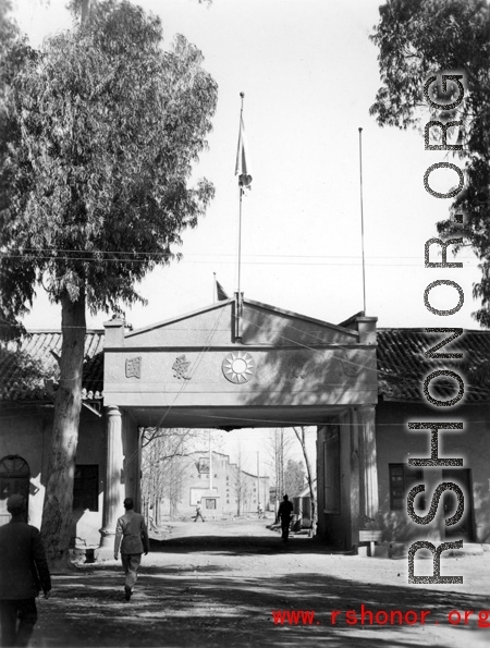 The entrance to a Nationalist government facility in Yunnan province, China.  Above the gate is a slogan, "Be faithful to the party, be patriotic." During WWII.