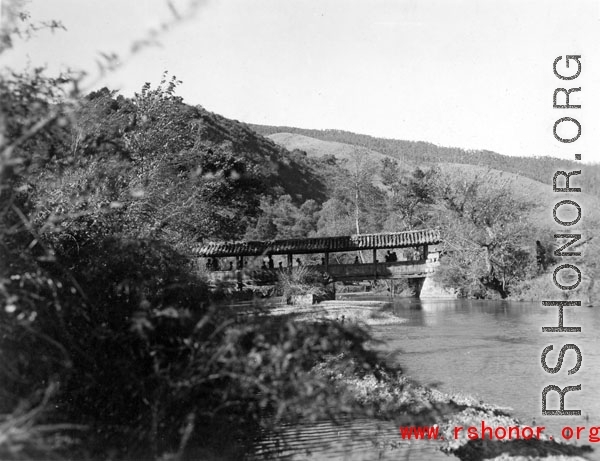 A covered pedestrian bridge in Yunnan province, China. During WWII.