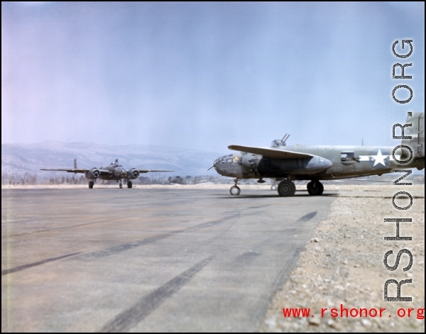 B-25 'Mitchell' bombers of the Ringer Squadron perform engine checks prior to taking off on a mission. These three aircraft (nose wheel of third is visible underneath #450, on the right) are on the runway at Yangkai AB, in Yunnan province, China.