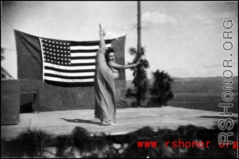 During a USO show at an American airbase Betty Yeaton performs for the service men. October 1944.