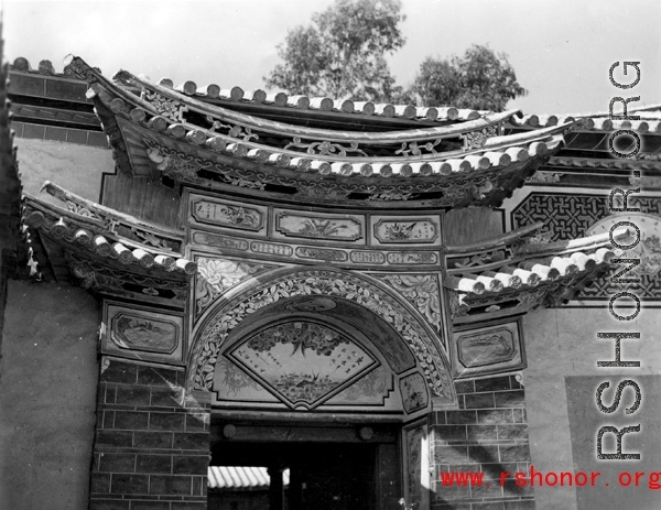 Architecture in Yunnan province, China during the Second World War: An ornate entry door to a home compound, during WWII.  From the collection of Eugene T. Wozniak.