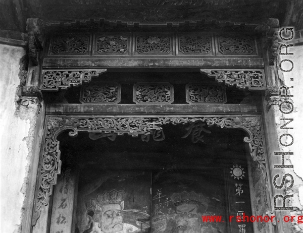 Wood carvings around the door of a compound that has been taken over for use by the Nationalist government. Architecture in Yunnan province, China.