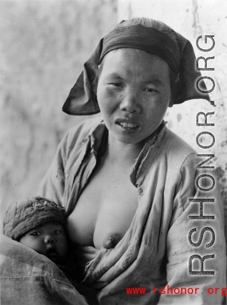 A nursing mother and child in China during WWII.