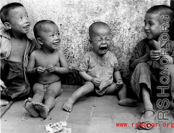 Local kids in China during WWII, including one who is very upset about something. During WWII.