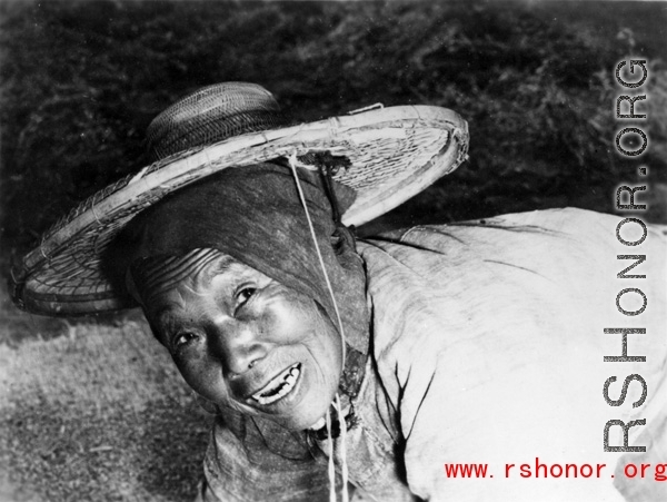 Local people in China: An elderly woman works in the farm fields during WWII.