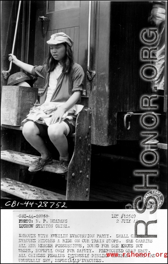 Enroute with Kweilin evacuation party. Small Chinese evacuee hitches a ride on our train stops. She carries all her meager possessions, bound for she knows not where, hopeful only for safety. Pre-focused grab shot. All Chinese females intensely dislike cameras. They are unusually shy, especially evacuees.