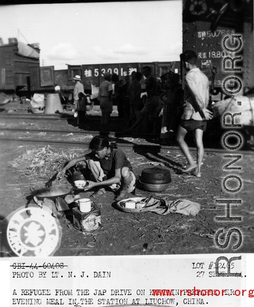 September 27, 1944  During WWII, a refugee from the Japanese Ichigo drive on Kweilin (Guilin) prepares her evening meal in the station at Liuchow, China.