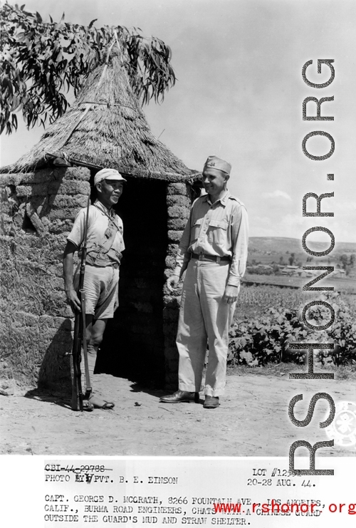 20-28 August 1944  Capt. George D. McGrath, 8266 Fountain Ave., Los Angeles, Calif., Burma Road Engineers, chats with a Chinese guard outside the guard\'s mud and straw shelter, during WWII.  Photo by Pvt. B. E. Einson