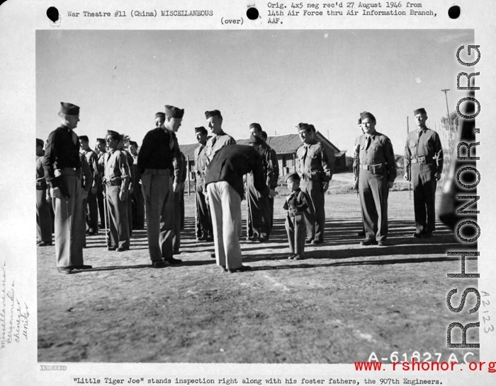 "Little Tiger Joe" stands inspection right along with his foster fathers, the 907th Engineers in the CBI (China) during WWII.