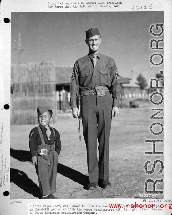 "Little Tiger Joe", well known to the 14th Air Force stationed in China, on the drill ground at 14th Air Force Headquarters with 1st Sgt. Robert Duerson of the 907th Engineers Headquarters Company, in the CBI during WWII.