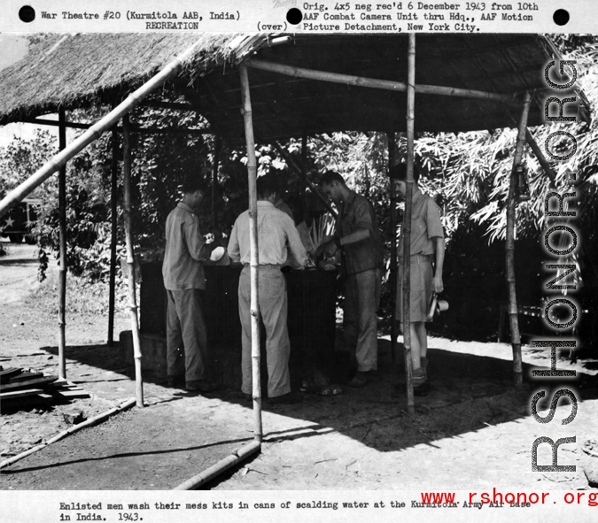 Enlisted men wash their mess kits in cans of scalding water at the Kurmitola Army Air Base in India in 1943.   In the CBI during WWII.