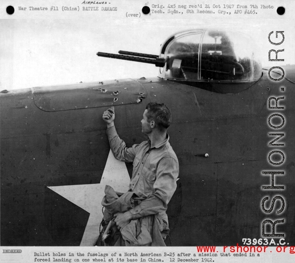 Bullet holes in the fuselage of the North American B-25 after a mission that ended in a forced landing on one wheel at its base in China.  December 12, 1942.