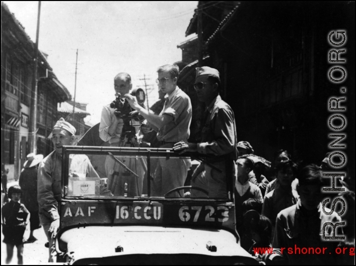 Americans in Jeep shooting movie film in a Chinese town, probably Kunming.