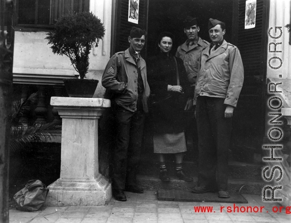 An elite Chinese woman poses with American servicemen and local people in Yunnan province, China, during WWII. 