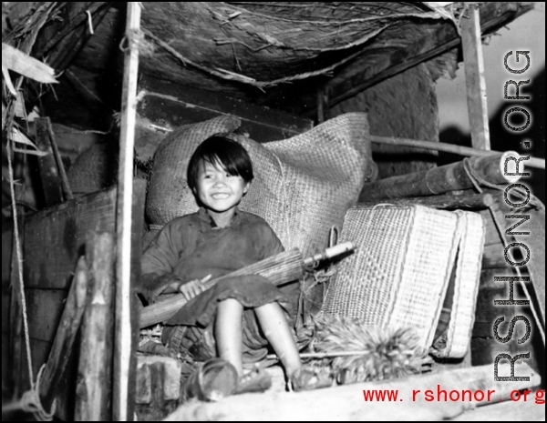 A refugee child rides a cart near around either Liuzhou or Guilin during the evacuation before the Japanese Ichigo advance in 1944, in Guangxi province.