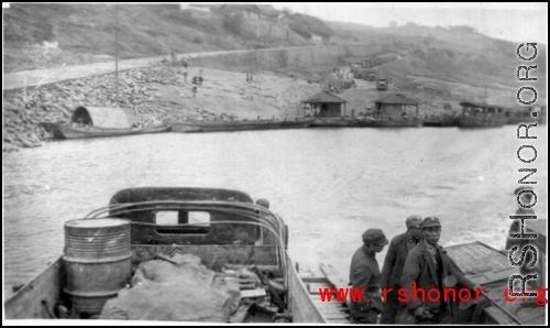 On a ferry with Chinese soldiers crossing a river in southwest China during WWII.