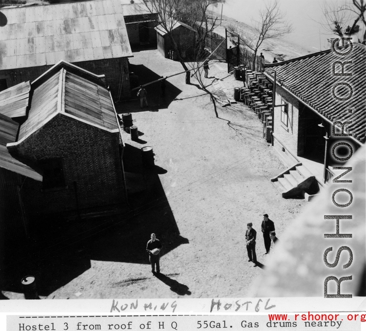 Kunming Hostel: "Hostel #3 from roof of HQ, 44 Gal. gas drums nearby"  Note man holding basketball in foreground.