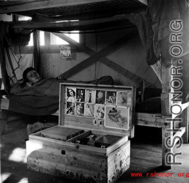 Barracks life at an American base in southwest China during WWII: Bunk, chest, and pin-ups.