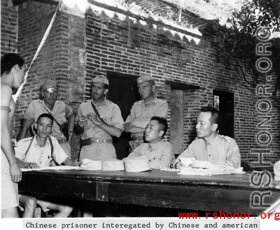 A Chinese prisoner being interrogated by the Chinese and Americans during WWII.