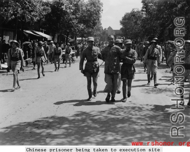 A Chinese prisoner being taken to execution site by Nationalist soldiers during WWII.