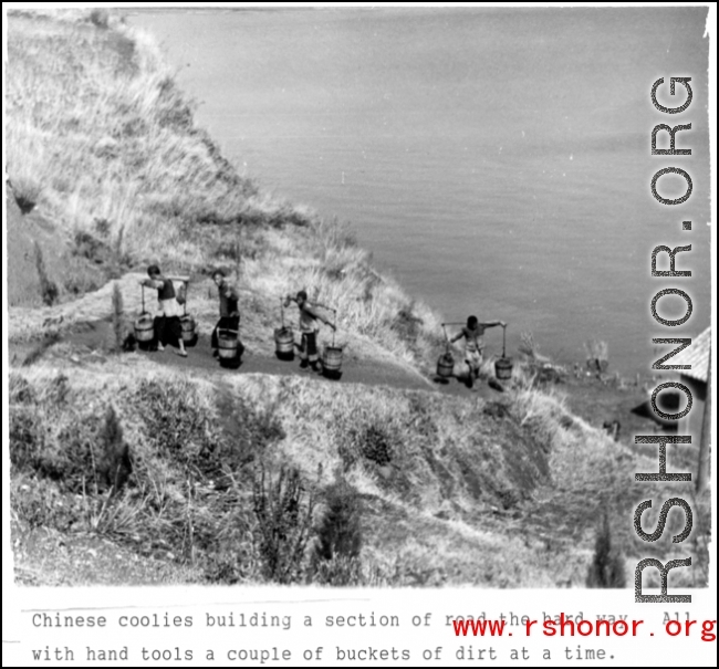 Chinese laborers extract water from the lake near Camp Schiel, Yunnan province, to use to build a road, work done by hand tools and hard labor. During WWII.