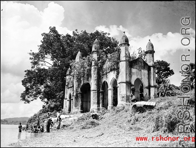 An overgrown riverside structure in the countryside of India or Burma, during WWII.