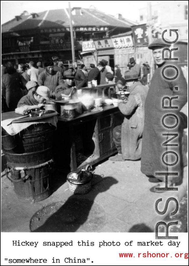 Local people get a tasty breakfast at a breakfast stand at a market somewhere in China during WWII.  Hickey.