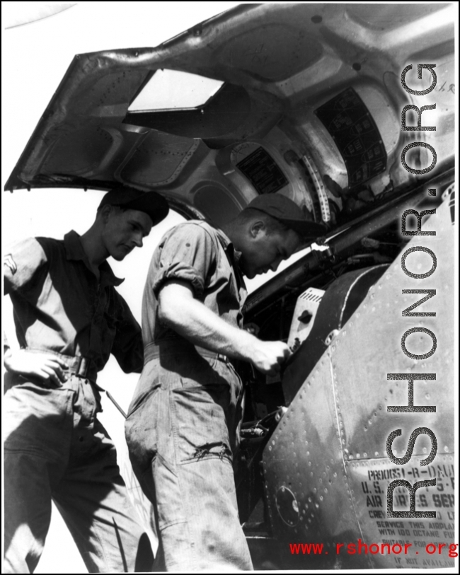 GIs change film on an F-5 (a reconnaissance version of the P-38) in the CBI during WWII.