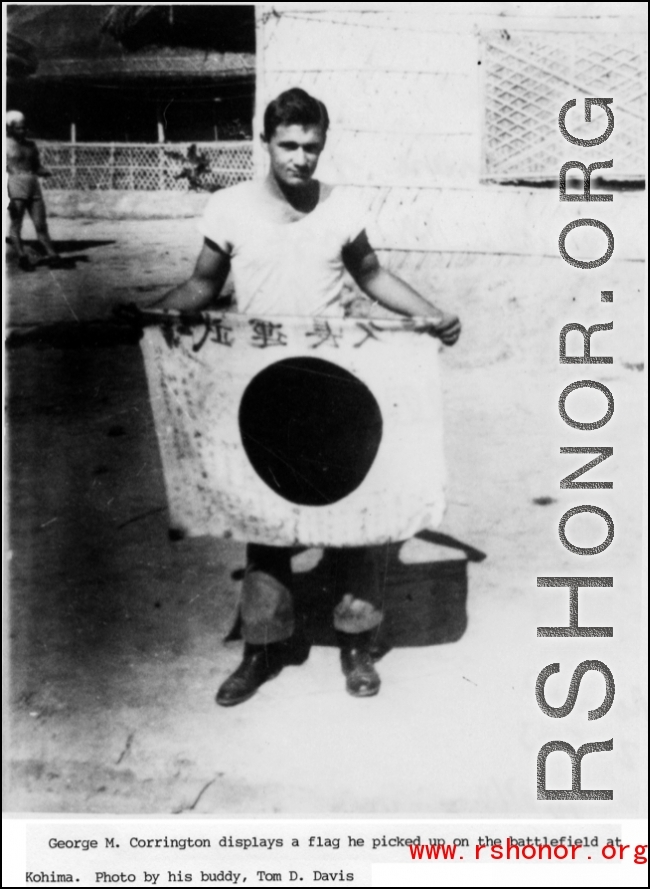 George M. Corrington display a  shows off trophy captured Japanese Good-Luck Flag  (寄せ書き日の丸) he picked up at battlefield at Kohima.  Photo by Tom D. Davis.