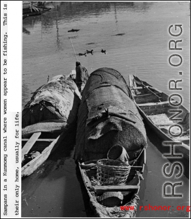 Boats in a Kunming canal, where women appear to be fishing. These boats are also their homes. During WWII.