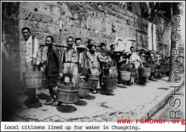 Local citizens lined up with buckets to collect water at Chongqing (Chungking), China, during WWII.