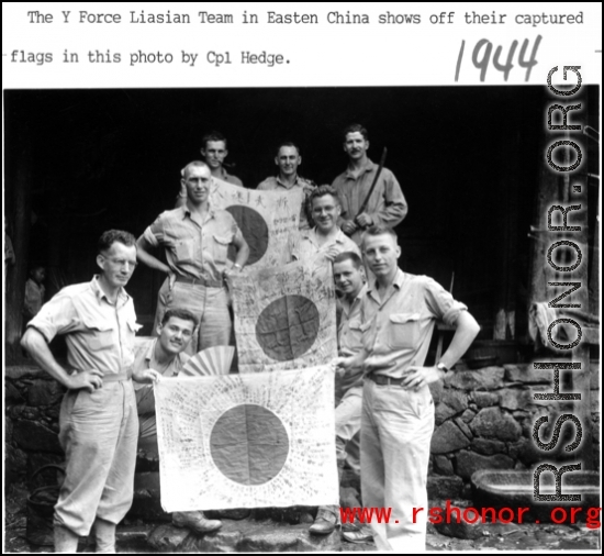 Y Force liaison team shows of captured Japanese Good-Luck Flags  (寄せ書き日の丸) collected on the battleground in the CBI during WWII. 1944.  Photo by Cpl. Hedge.