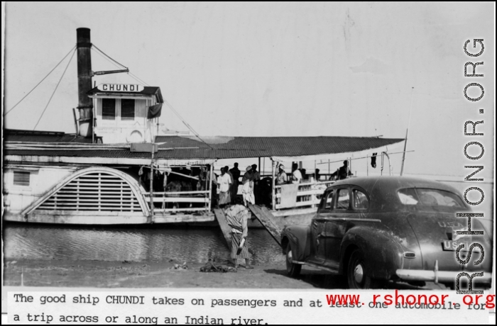 The boat "CHUNDI" takes on passengers and one automobile for travel on an Indian river during WWII.