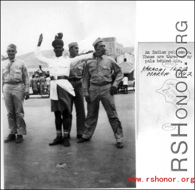 GIs pose with traffic policeman in Karachi, India, March 1942.