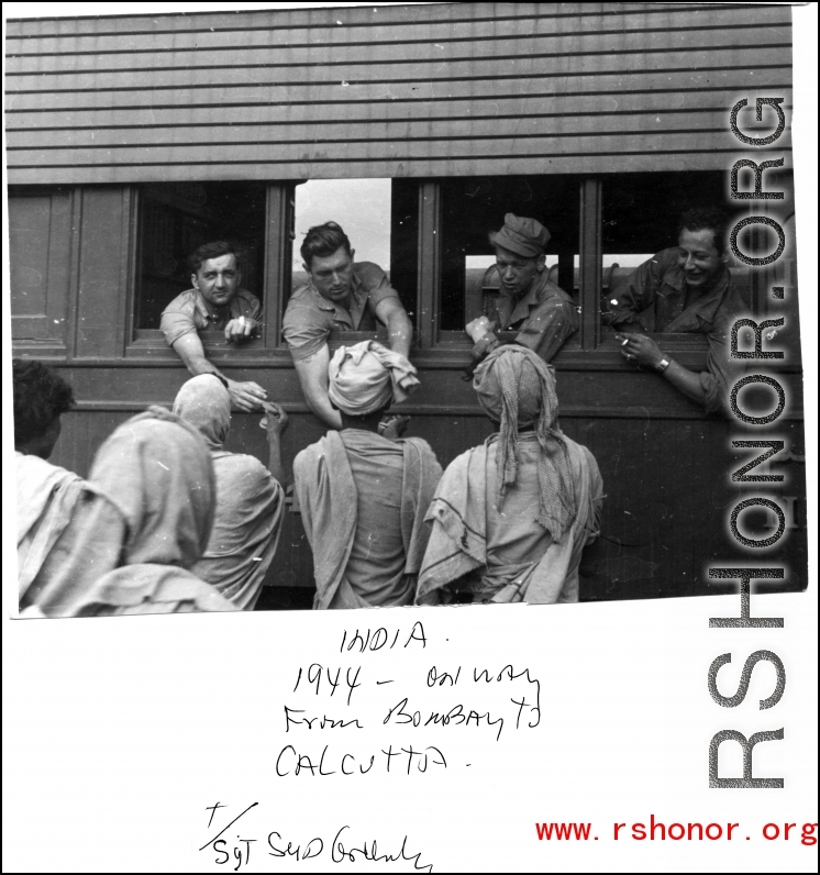 GIs in train from Bombay to Calcutta in 1944, talk to local men in India.  Photo by Syd Greenberg.