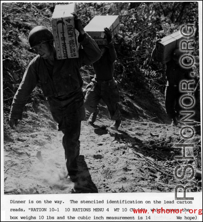 GIs carry 10 lb ration boxes on a trail, possibly after airdrop in Burma or SW China