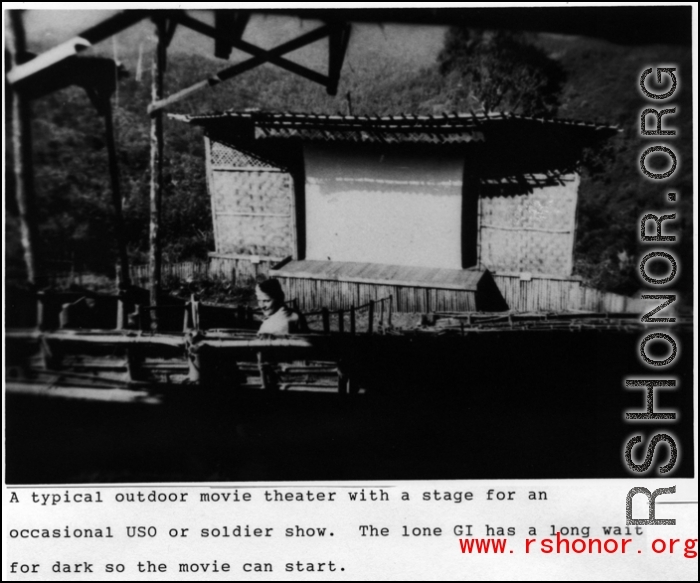 Lone GI has a long time to wait for the show to start at this typical outdoor theater in the CBI during WWII.