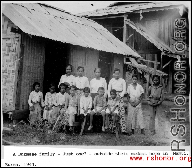 A Burmese family outside their home at Namti, Burma, 1944.