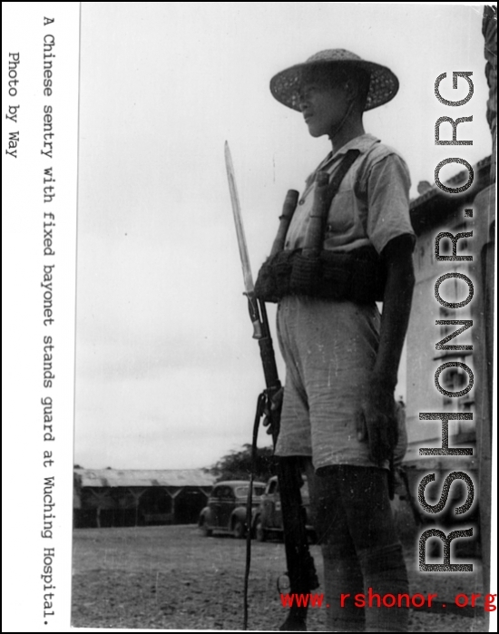 Armed Chinese guard at Wuchang Hospital during WWII.  Photo by Way.