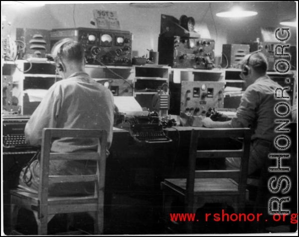 Tightly packed radio room in the CBI during WWII, with American GIs busy at the equipment.