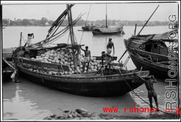 A boat full of coconuts in India or Burma, during WWII.