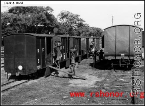 A train being loaded by hand in India during WWII.